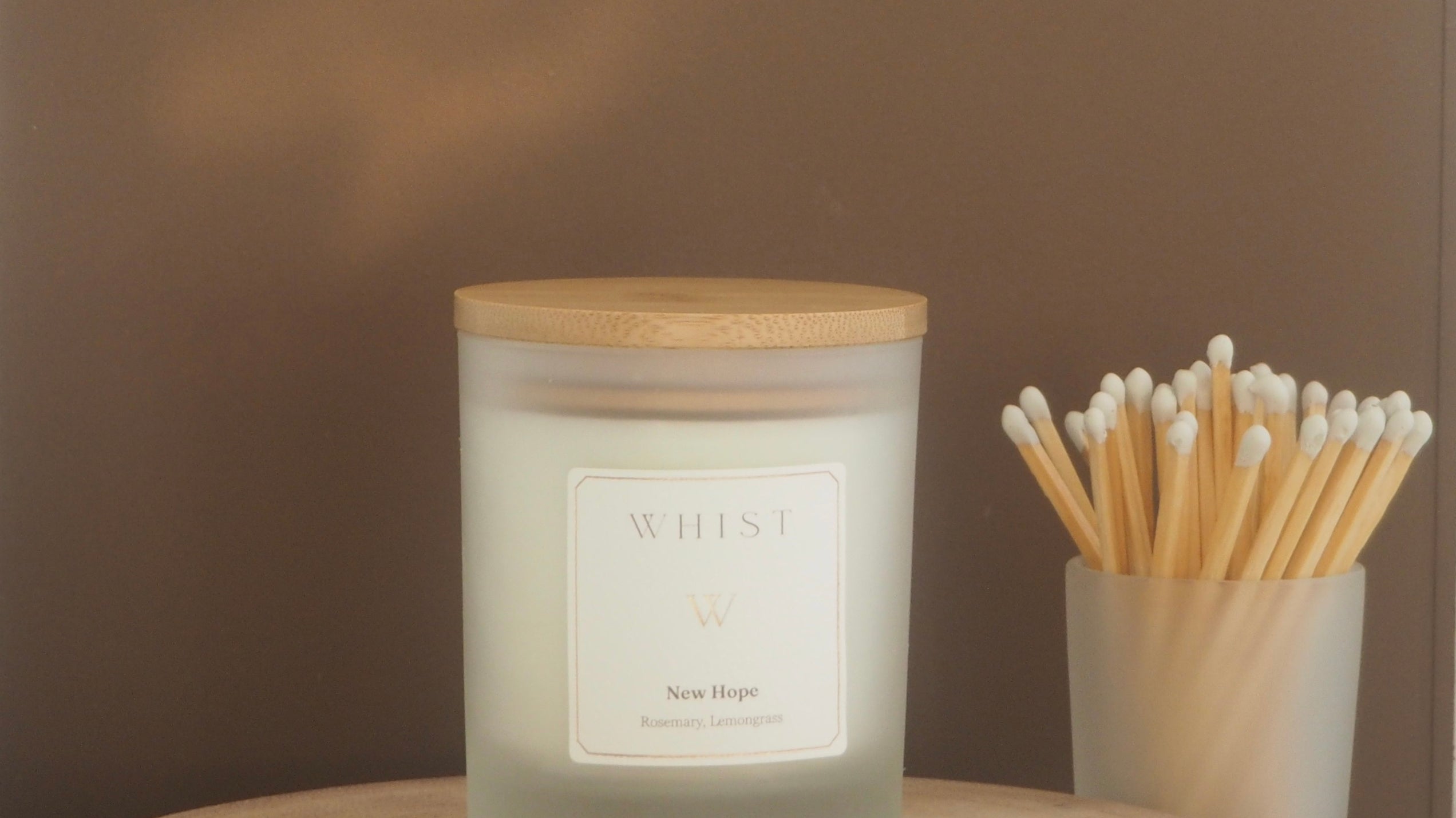 a whist candle - frosted glass with a bamboo wooden lid