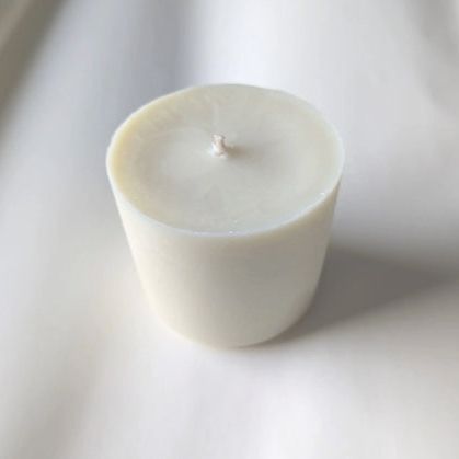 picture shows a white candle refill on a work surface