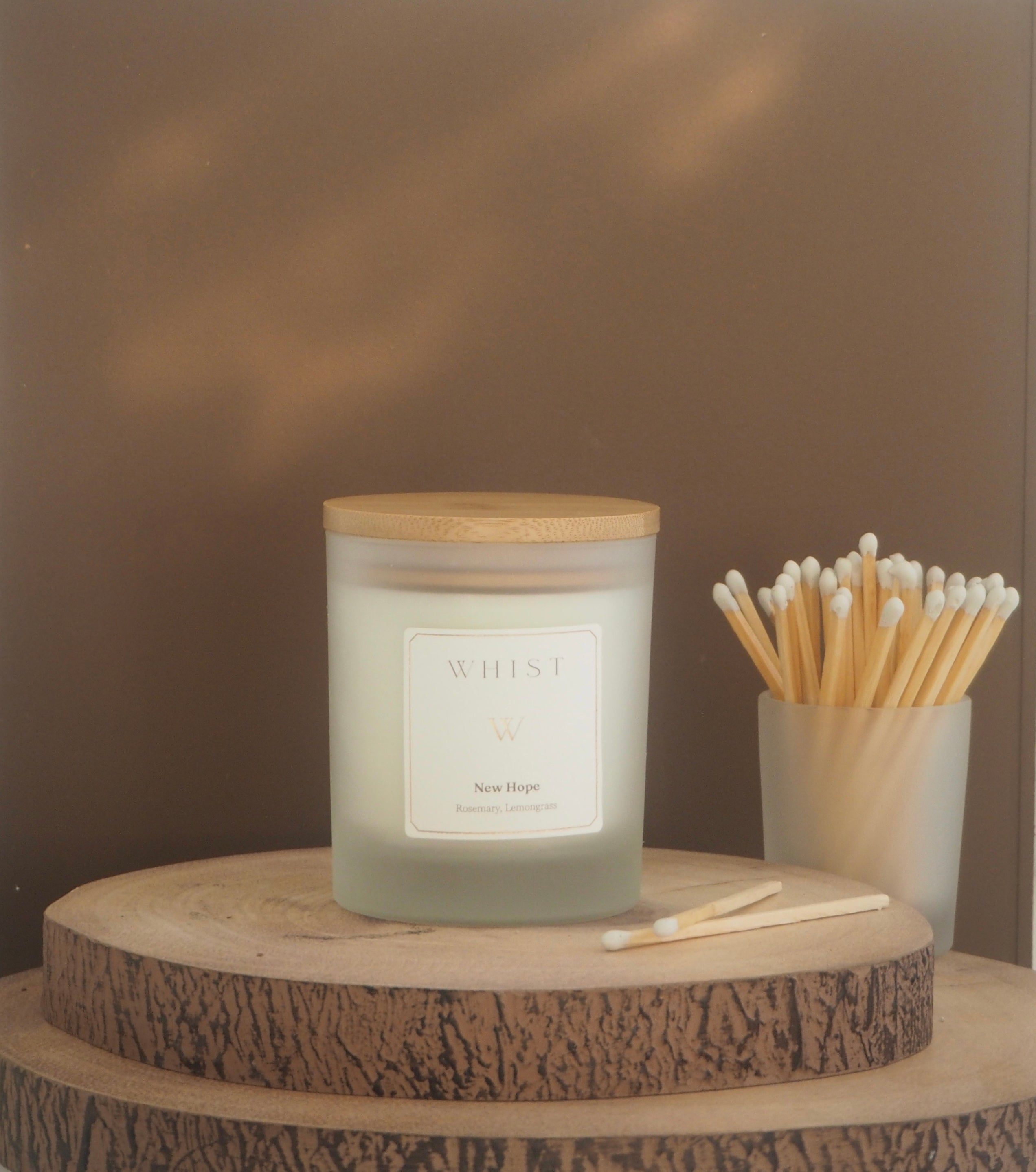 a whist candle - frosted glass with a bamboo wooden lid
