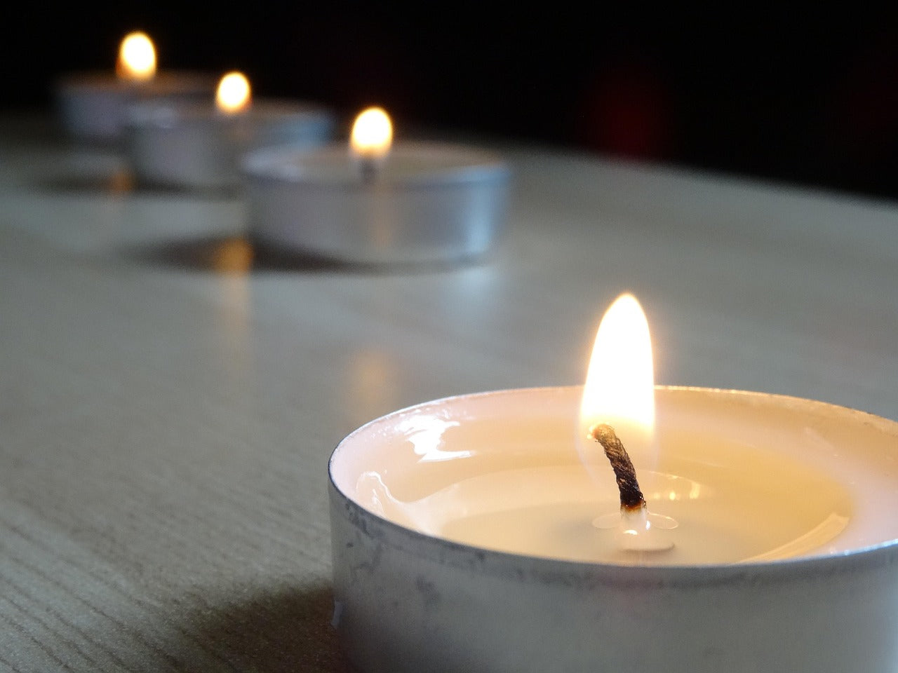 a row of lit tea lights 